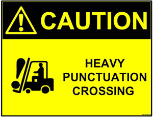 A poster advising 'Caution: Heavy Punctuation Crossing.' There is an image of a forklift carrying an exclamation mark.
