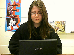 A photograph of a female student using a laptop computer.