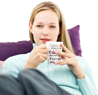 Woman sitting with cup of coffee
