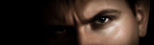 Photo of a man’s two dark, menacing eyes