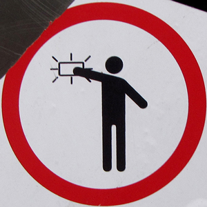 A sticker with a person sticking something to a surface