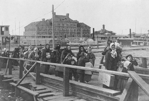 A photograph of immigrants landing at Ellis Island in the early 1900's.