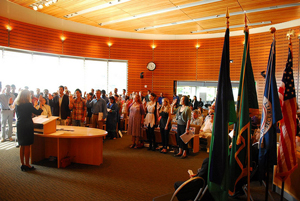 A photograph of people at a naturalization ceremony becoming U.S. citizens