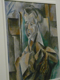 Pablo Picasso painting: a cubist rendition of a woman in browns and greens.