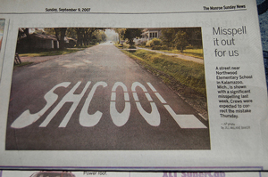 A photograph of a school crossing where the word school is misspelled 'shcool'