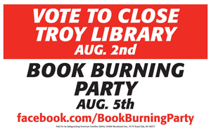 satirical sign that reads “Vote to Close Troy Library August 2nd, Book Burning Party Aug. 5th, facebook.com/BookBurningParty”