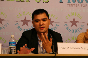A photograph of journalist and activist Jose Antonio Vargas seated at a conference table and speaking to an audience