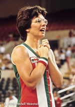 A photo from a 1978 Tennis match showing Billie Jean King. She looks like she may be about to speak, or she’s waiting for an announcement or result.