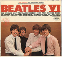 A photograph of the Beatles record sleeve: “Beatles VI.” It has a photo of the band with their arms extended with their hands lain on top of each other.