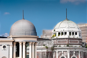 photo of two dome-shaped structures that very similar in shape and size, but are constructed from different materials and have different design details
