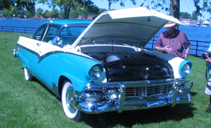 A photograph of a 1955 Ford Fairlane at an auto show