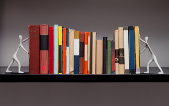 A row of books between bookends that look like people