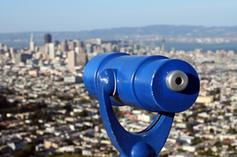 City skyline from above with telescope in foreground