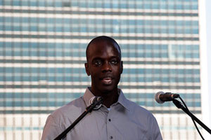 Image young man in front of a microphone.