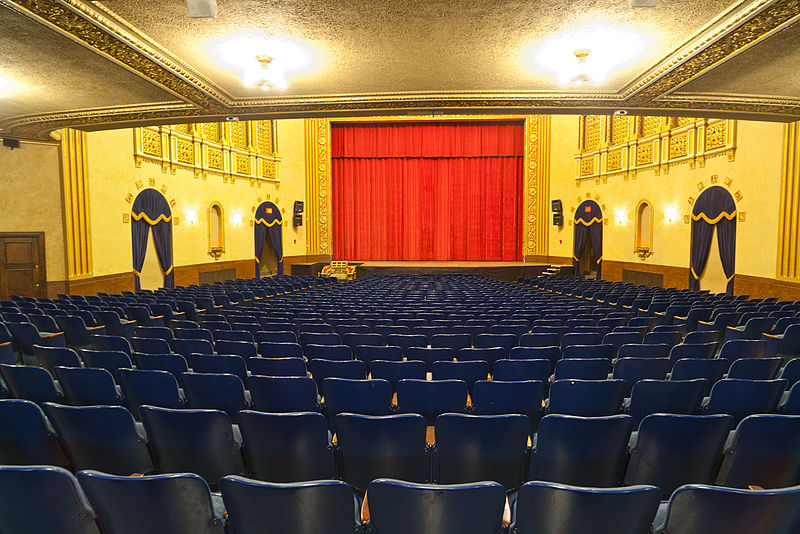 Raked Theater Seats Slope Down to a Proscenium Stage