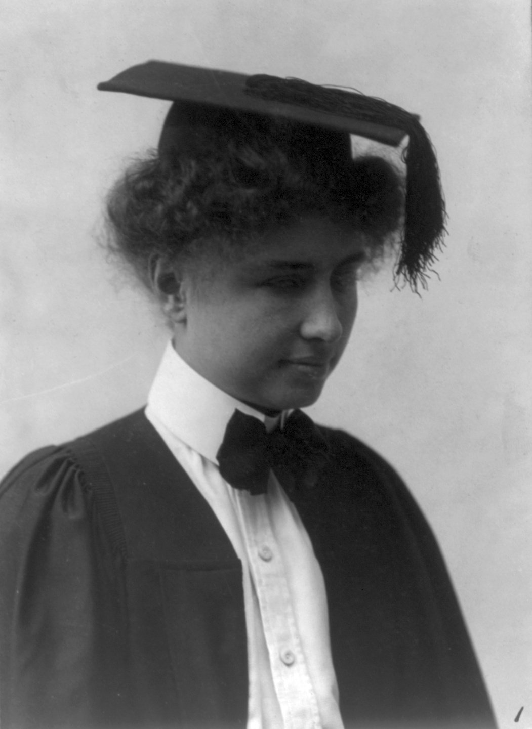 Photograph of Helen Keller with a mortarboard on her head