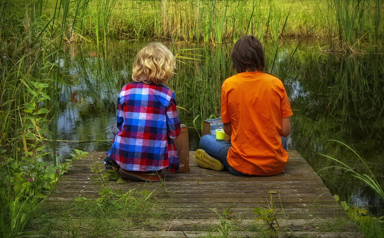 Friends sitting on a pier