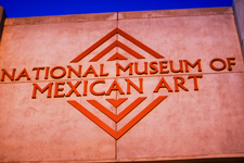 A photograph of the outside of a museum that has 'National Museum of Mexican Art' carved into it