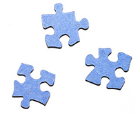 A photograph of three jigsaw puzzle pieces