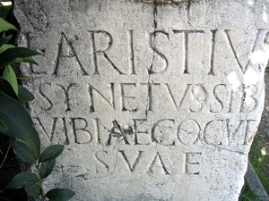 A photograph of a stone marker/slab with ancient Latin carved into it