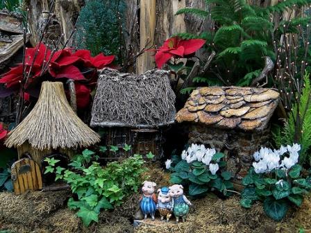 A photograph of a model village inhabited by the Three Little Pigs