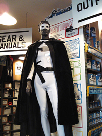 A photograph of a mannequin dressed as a caped superhero