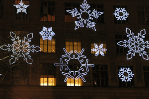 A photograph of neon snowflakes at night