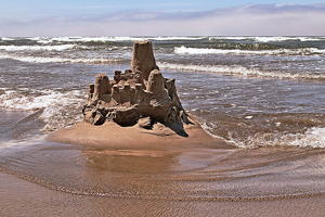 A photograph of a sand castle on a beach