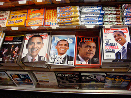 A photograph of a newsstand with many different types of magazines and other print periodicals.