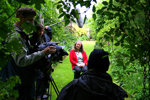 A photograph of a film crew making a documentary film.
