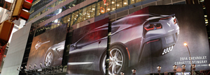 A billboard advertisement for the 2014 Corvette Stingray. It has a photo of the car.