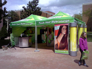 A photograph of a hair stylist tent sponsored by a shampoo brand.