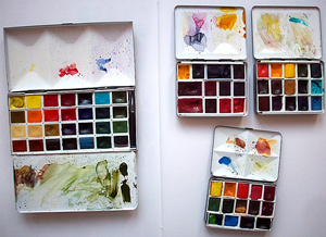 A photograph of three painter's palettes