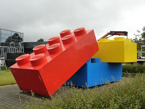 A photograph of an outdoor sculpture containing three giant, stacked Legos