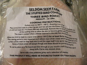 photo of a packaged whole chicken in a grocery store; the cooking directions are written on the outside packaging.