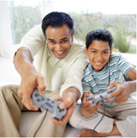 image of a man and boy playing video games