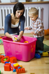 Woman with small child and a bucket of toys