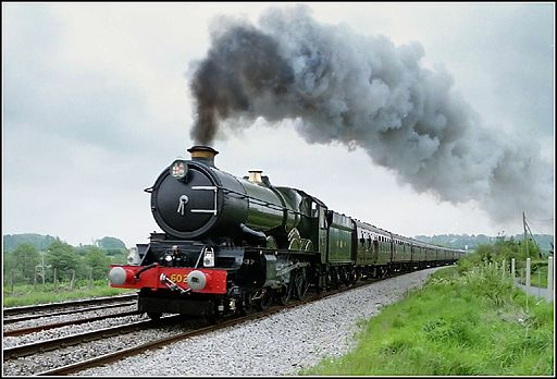 Steam engine train accelerating on a track