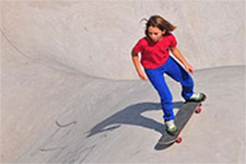 Image is of a girl skateboarding