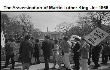 Image of people standing in front of the White House holding signs