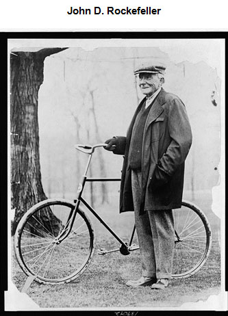 Image of John Rockefeller standing next to a bicycle