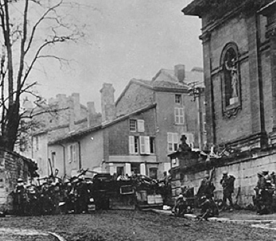 Image of soldiers waiting outside of a church amidst a war-torn city. 