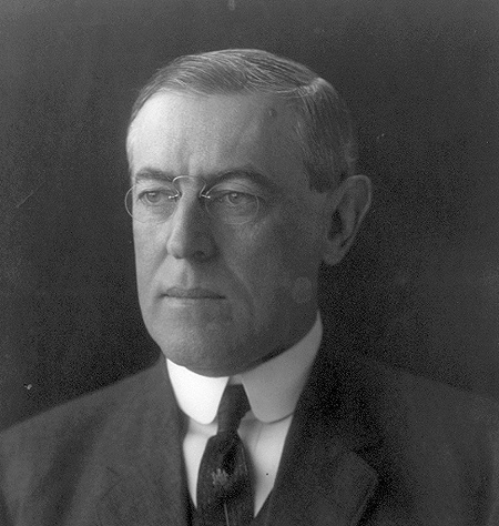 A photograph/portrait of US President Woodrow Wilson. He is a man in late middle age wearing glasses and a suit with a tie.