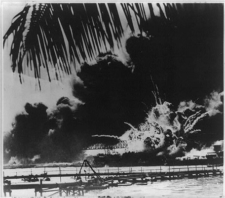 Image of a bridge and naval ship being bombed