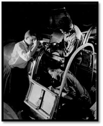 Image of three African-American men assembling the cockpit of an airplane