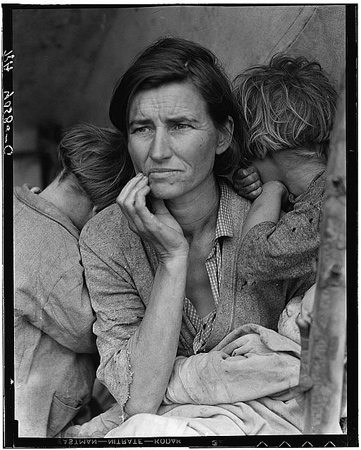 Destitute pea picker Florence Thompson with several of her children, photographed in Nipomo, California. She is holding and infant and her other two children are looking away from the camera.