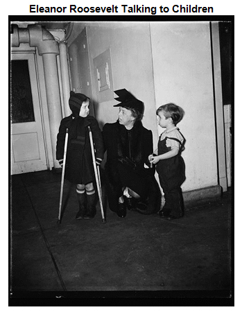 Image of Eleanor Roosevelt, kneeling, speaking to two children