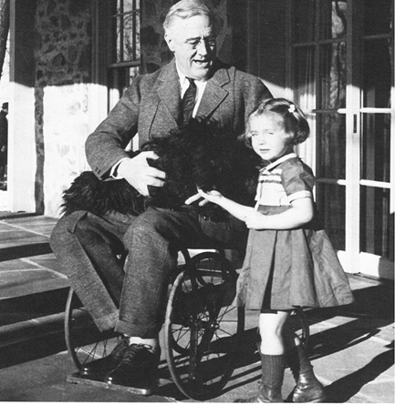 Image of FDR sitting in a wheelchair, holding a dog. A young girl is standing next to him.