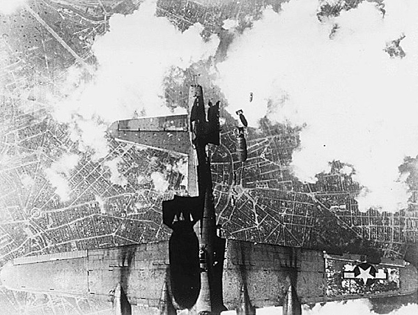 Image of US Air Force airplane as it drops torpedoes onto Berlin. The view is taken from a German bombardier above which is also dropping a torpedo onto the US plane.