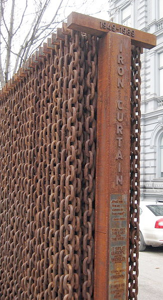 This is a structure made of a series of rusted chain links assembled to represent a curtain if chains. The years '1949-1989' are embossed on the top and 'Iron Curtain' is embossed on the side.